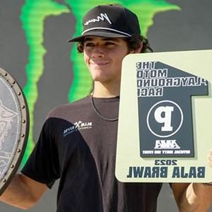 Image of Maddox, a motocross competitor here at a competition showing his 1st place award, he is a student at Colorado Connections Academy. 